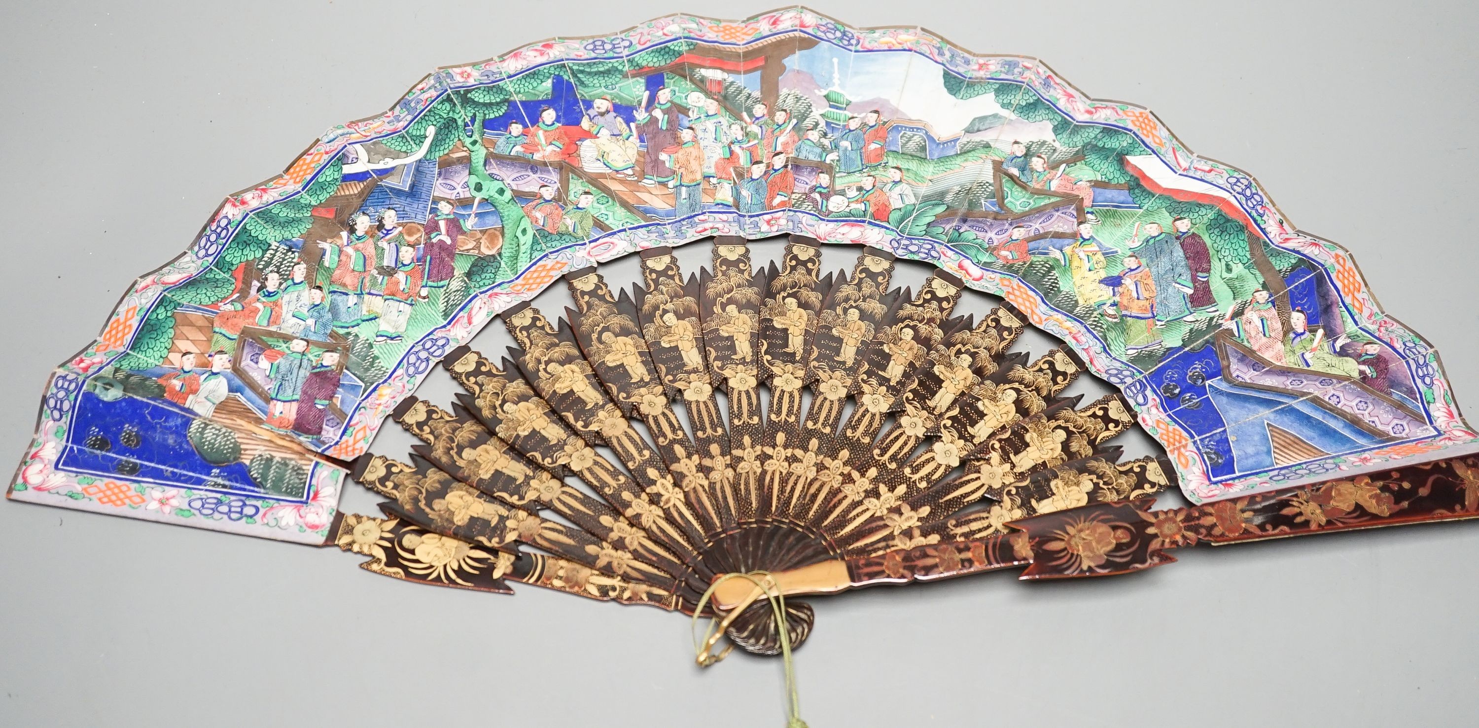 A Chinese export gilt decorated lacquer fan and box, mid 19th century, the appliqué work paper fan leaf decorated with figures amid pavilions and trees, box 32cm